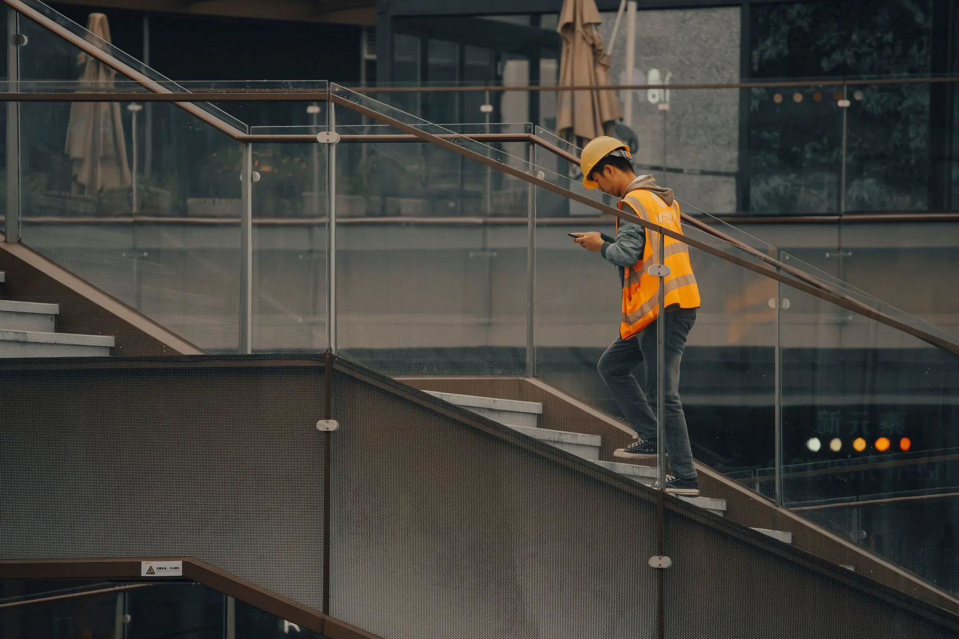 A construction worker using a mobile phone to record data on a building site — Avaib