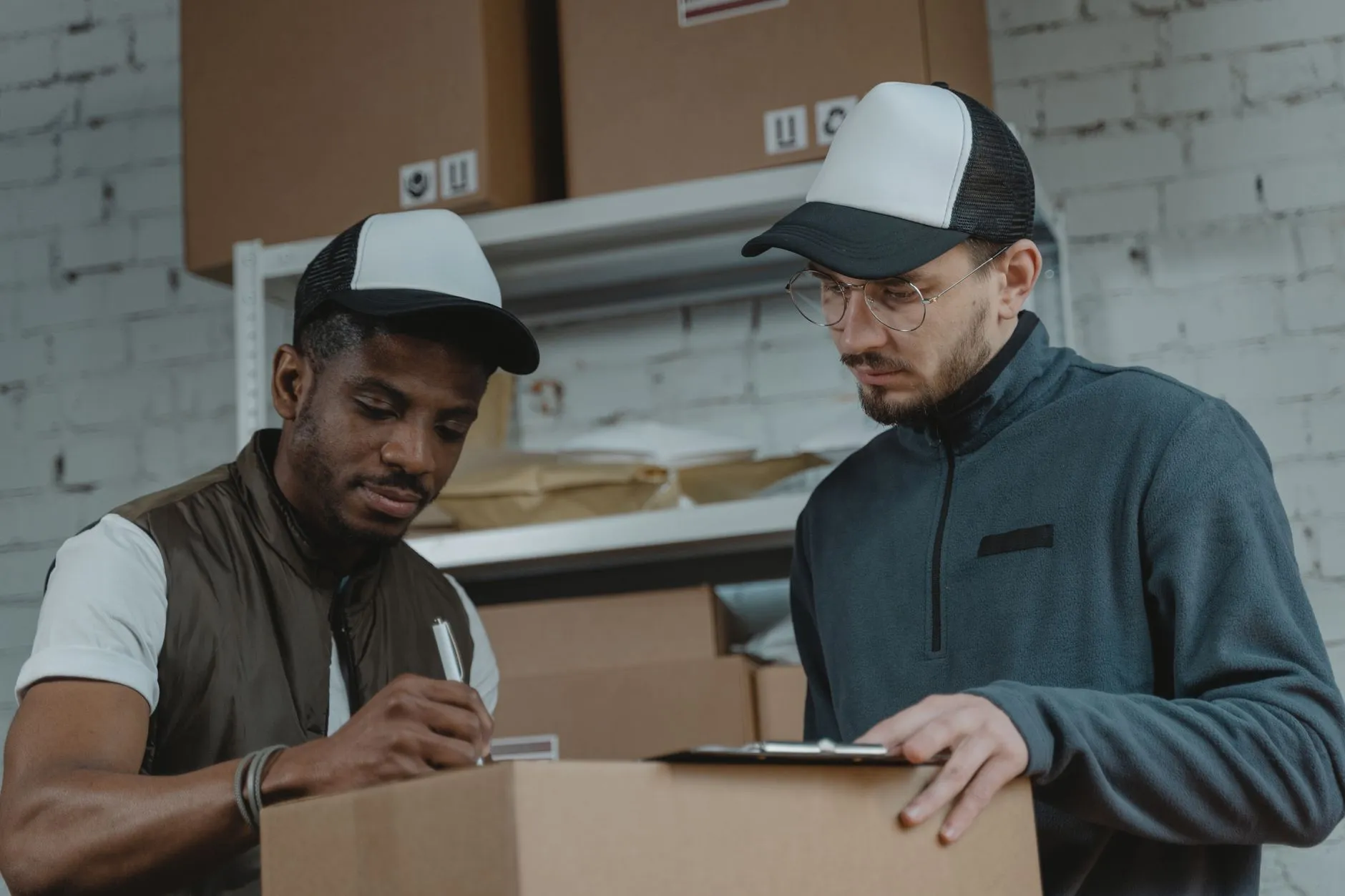 A courier scanning a package in a fulfilment warehouse — Avaib