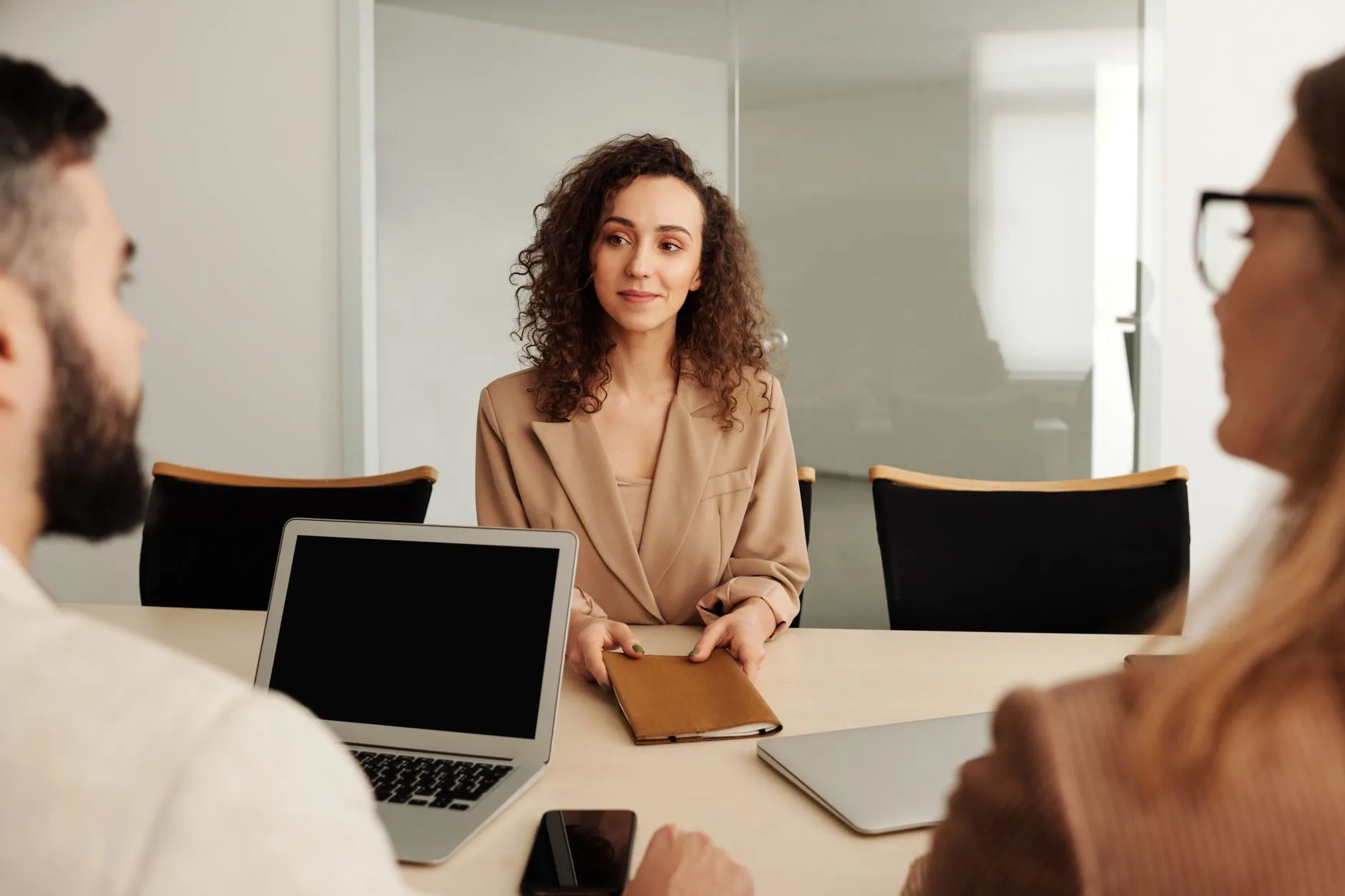 An HR manager onboarding a new employee at a desk — Avaib