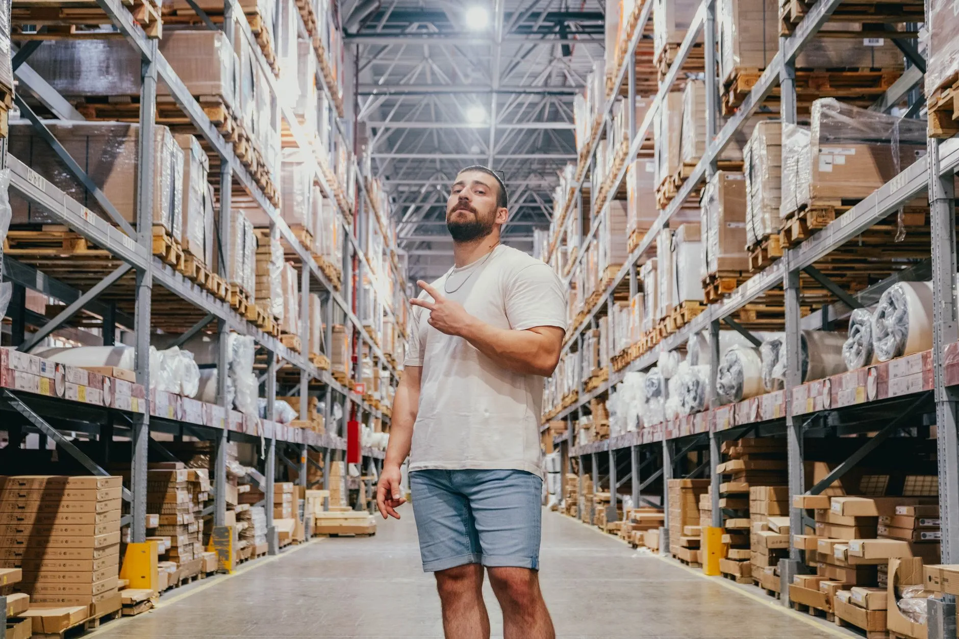 A warehouse worker fulfilling an online order at a packing bench — Avaib