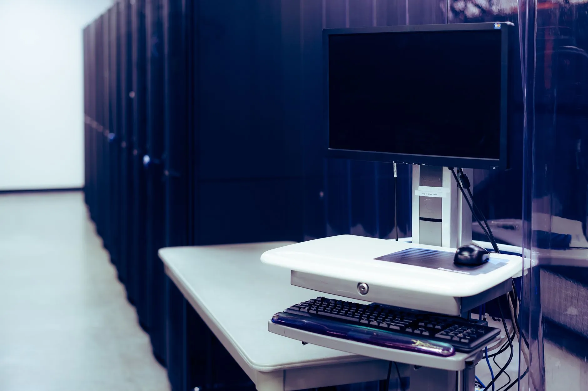 A network operations centre with server monitoring dashboards showing application uptime — Avaib