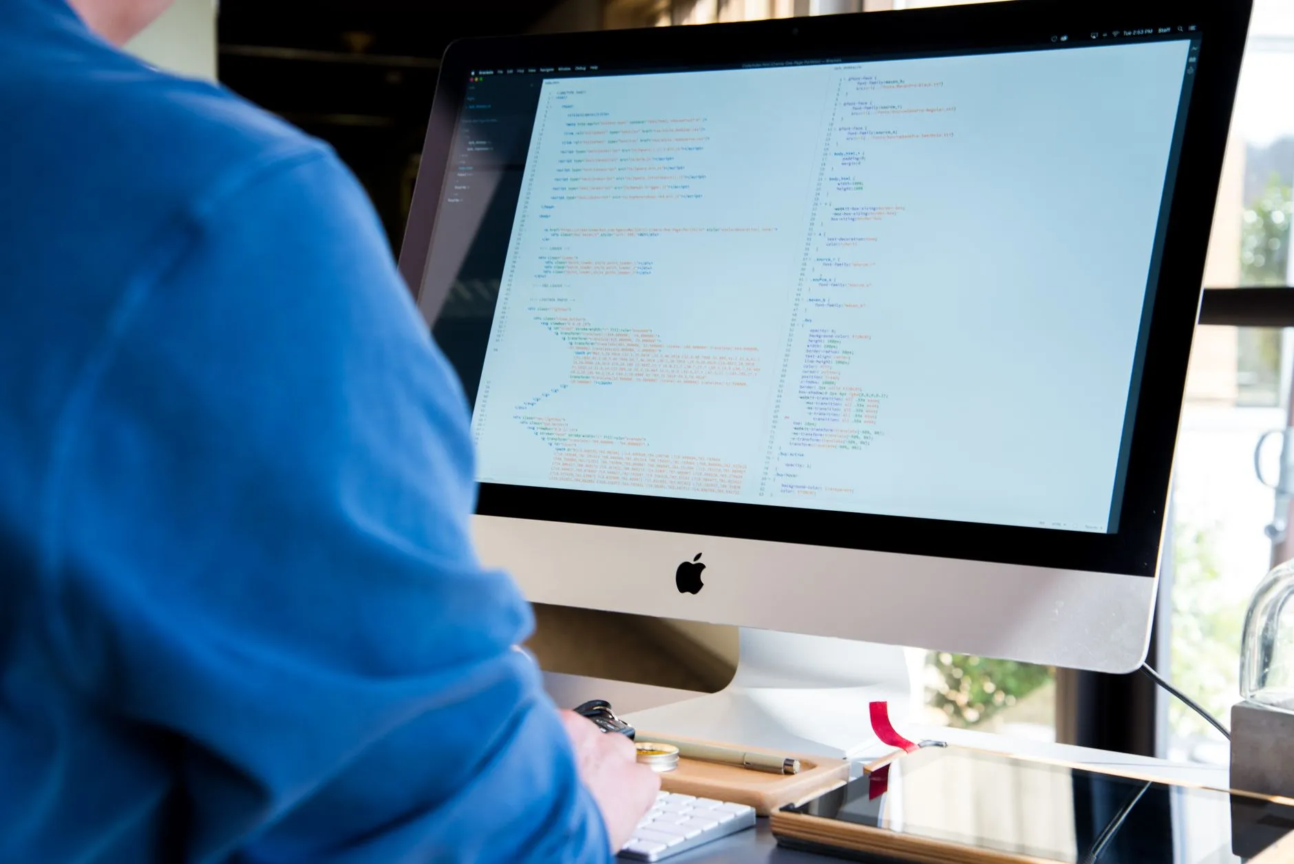 A developer making a small code change to a live application from a desk — Avaib