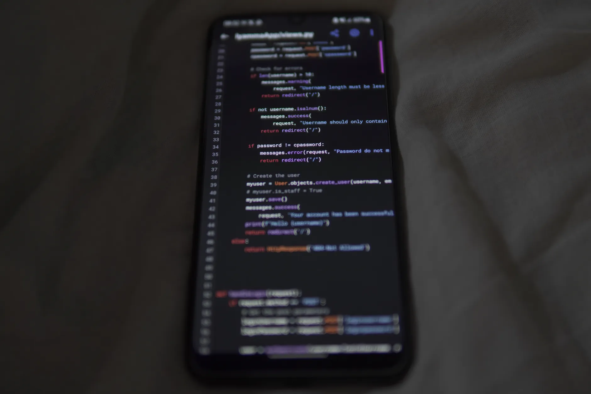 A developer reviewing legacy mobile app code on a laptop for modernisation — Avaib