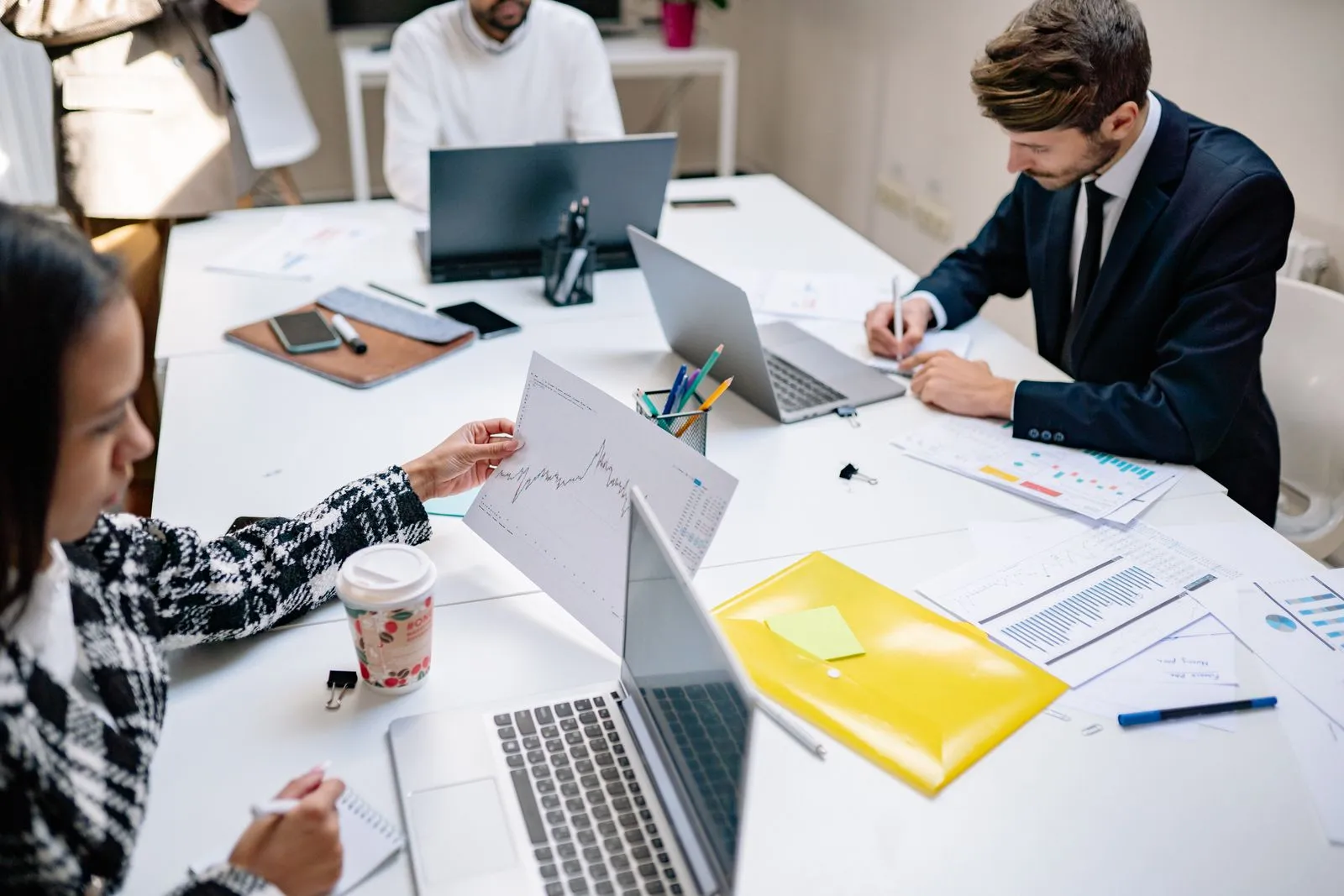 A software agency team collaborating around a laptop