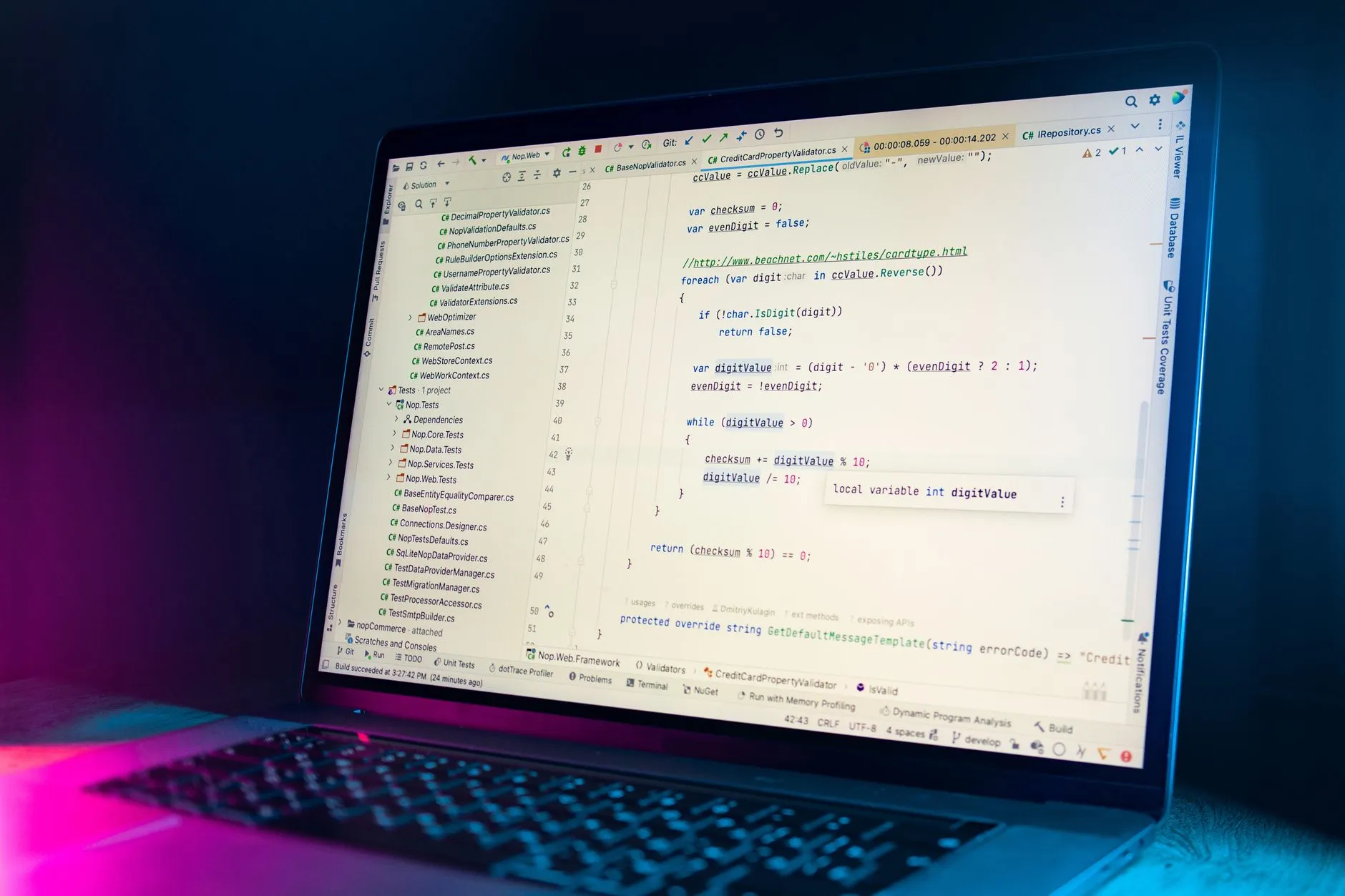 A backend developer writing REST API code on a monitor in a development environment — Avaib