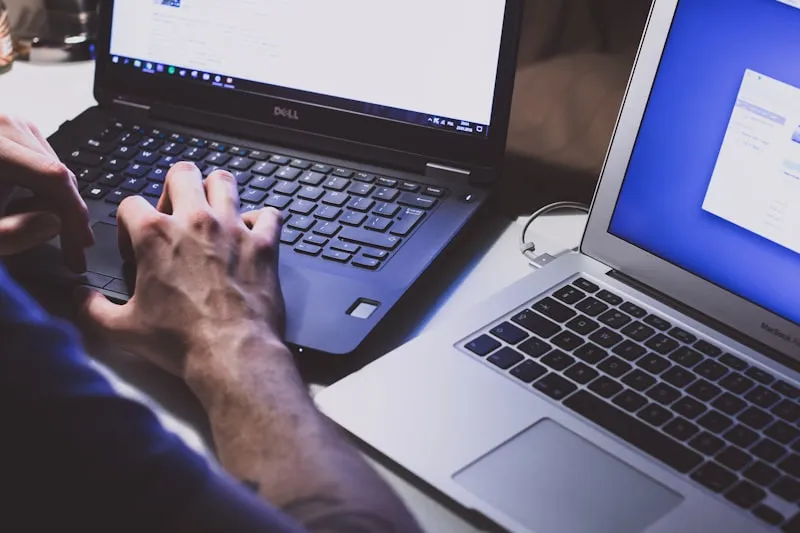 A software tester checking code on a laptop
