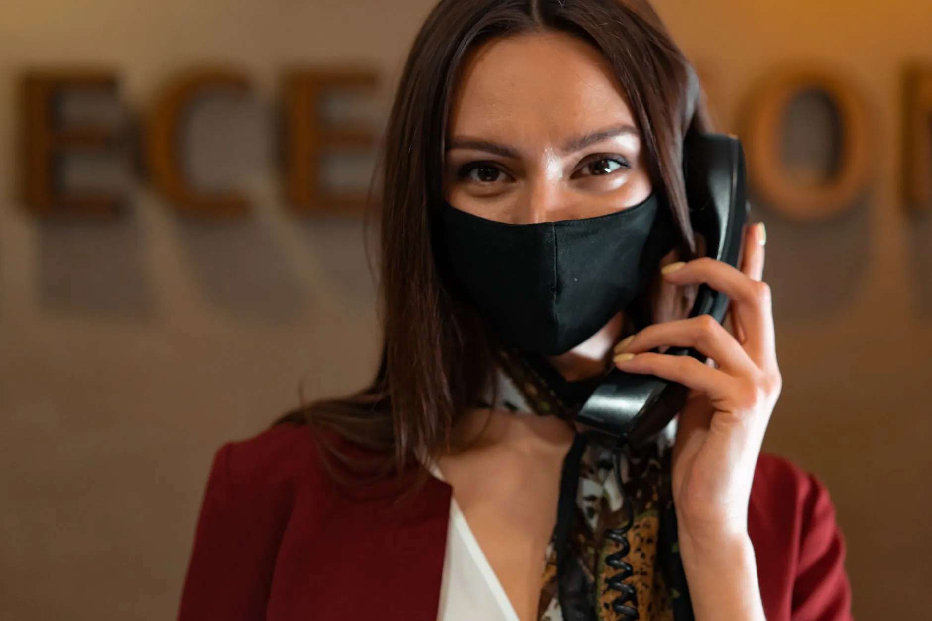 A receptionist answering the phone at a front desk in an office — Avaib