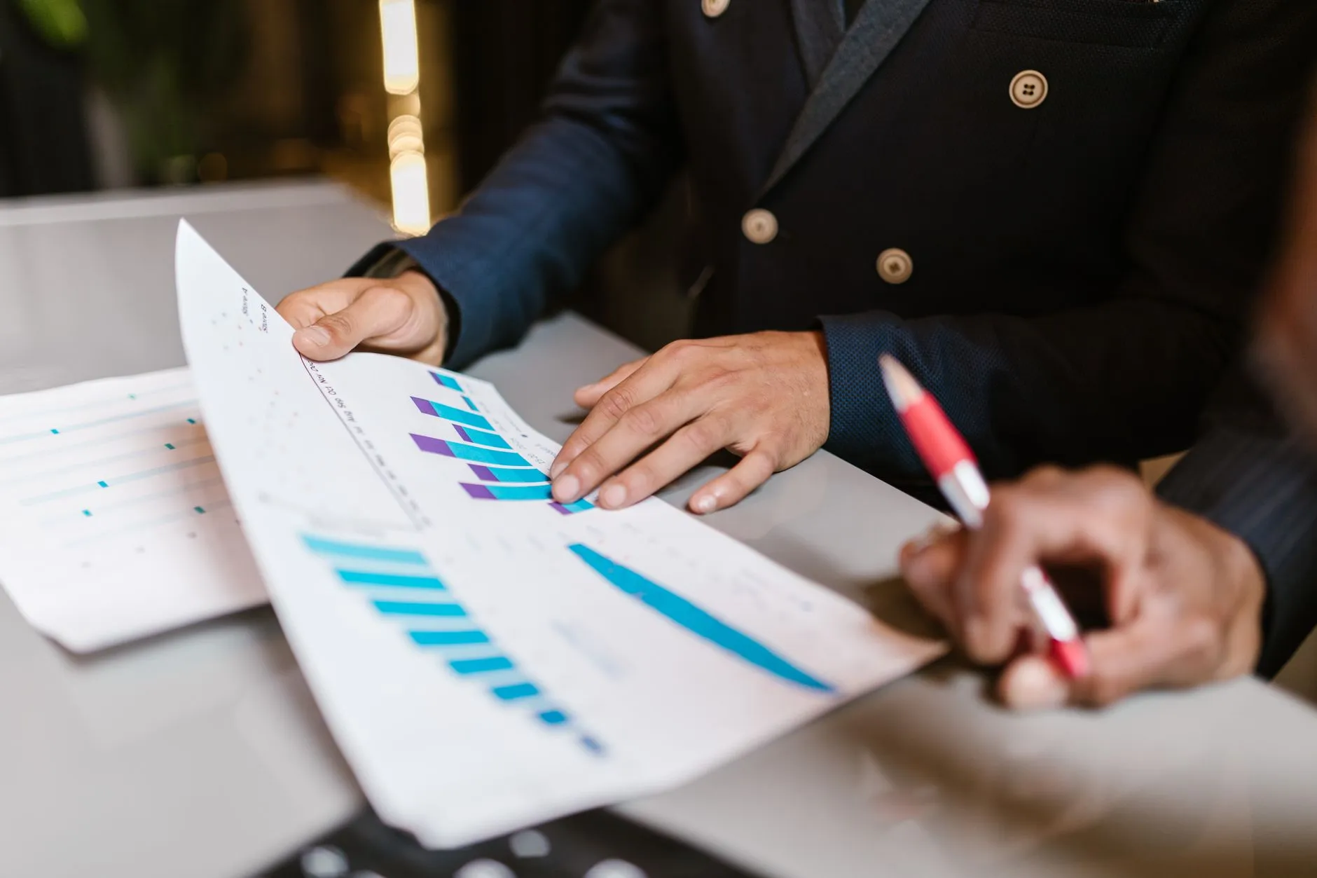 A business analyst reviewing a dashboard report on a computer screen — Avaib